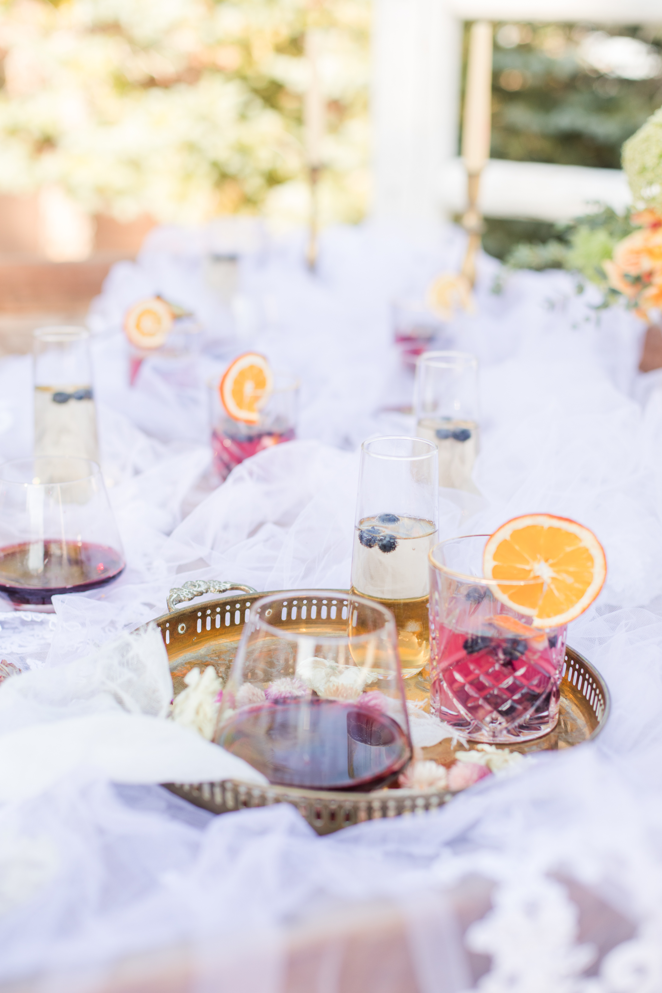 Celebration drinks garnished with dried orange on a lace table