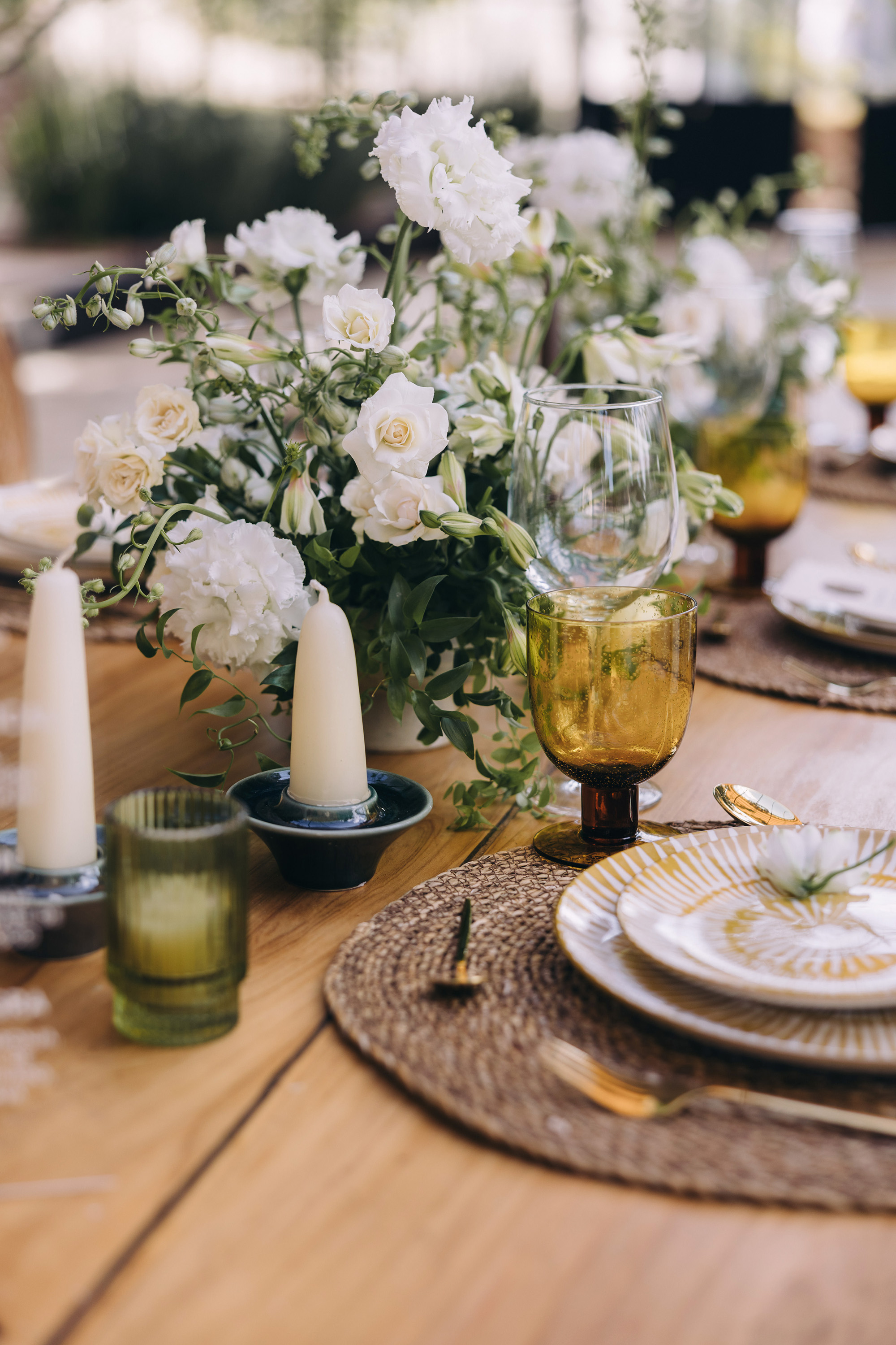 A catered wedding tablescape with candles and glassware