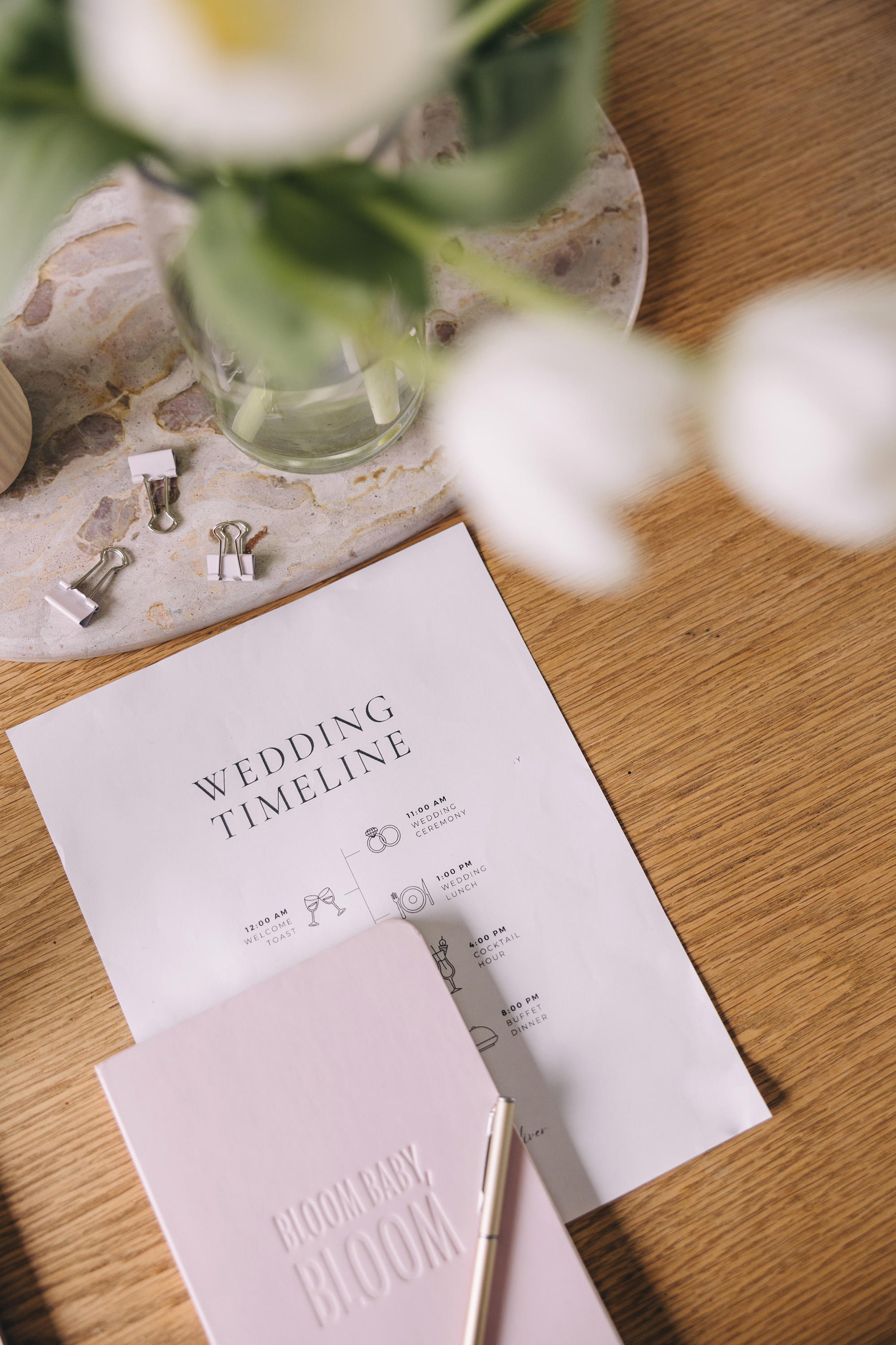 A notebook and printed timeline on a desk